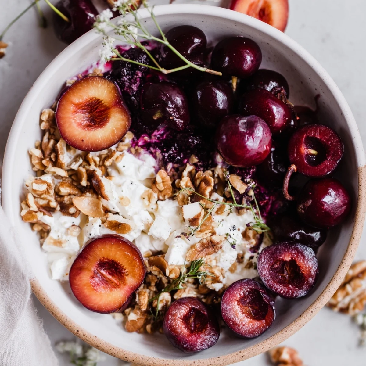 Midnight Orchard fruit and cheese platter with sweet cherries, plums, grapes, and creamy goat cheese.