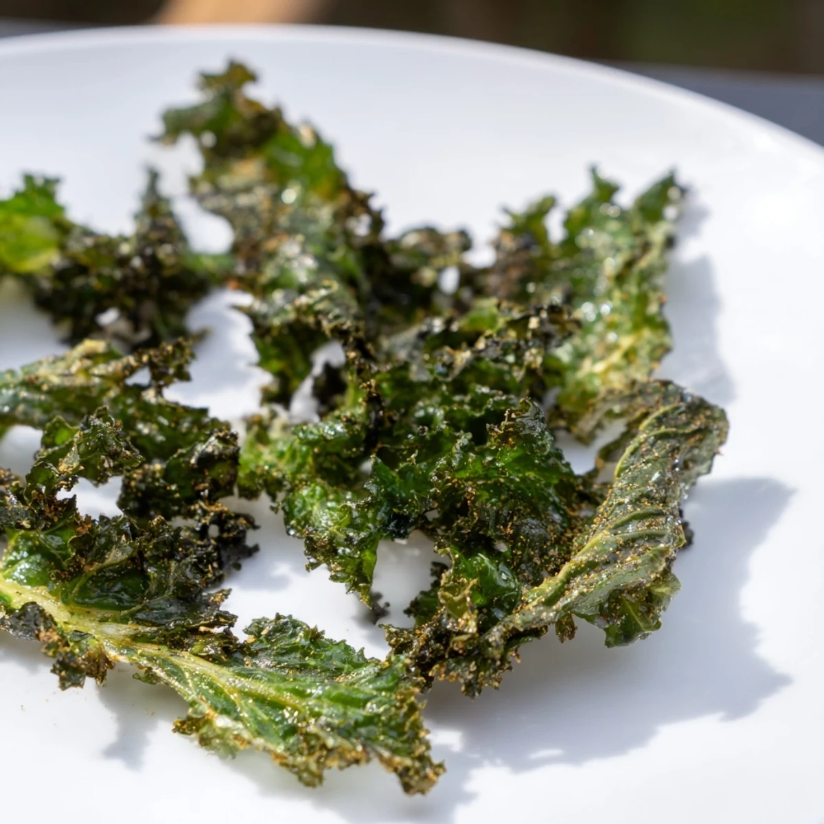Freshly baked crispy kale chips, golden and seasoned, a healthy American snack.
