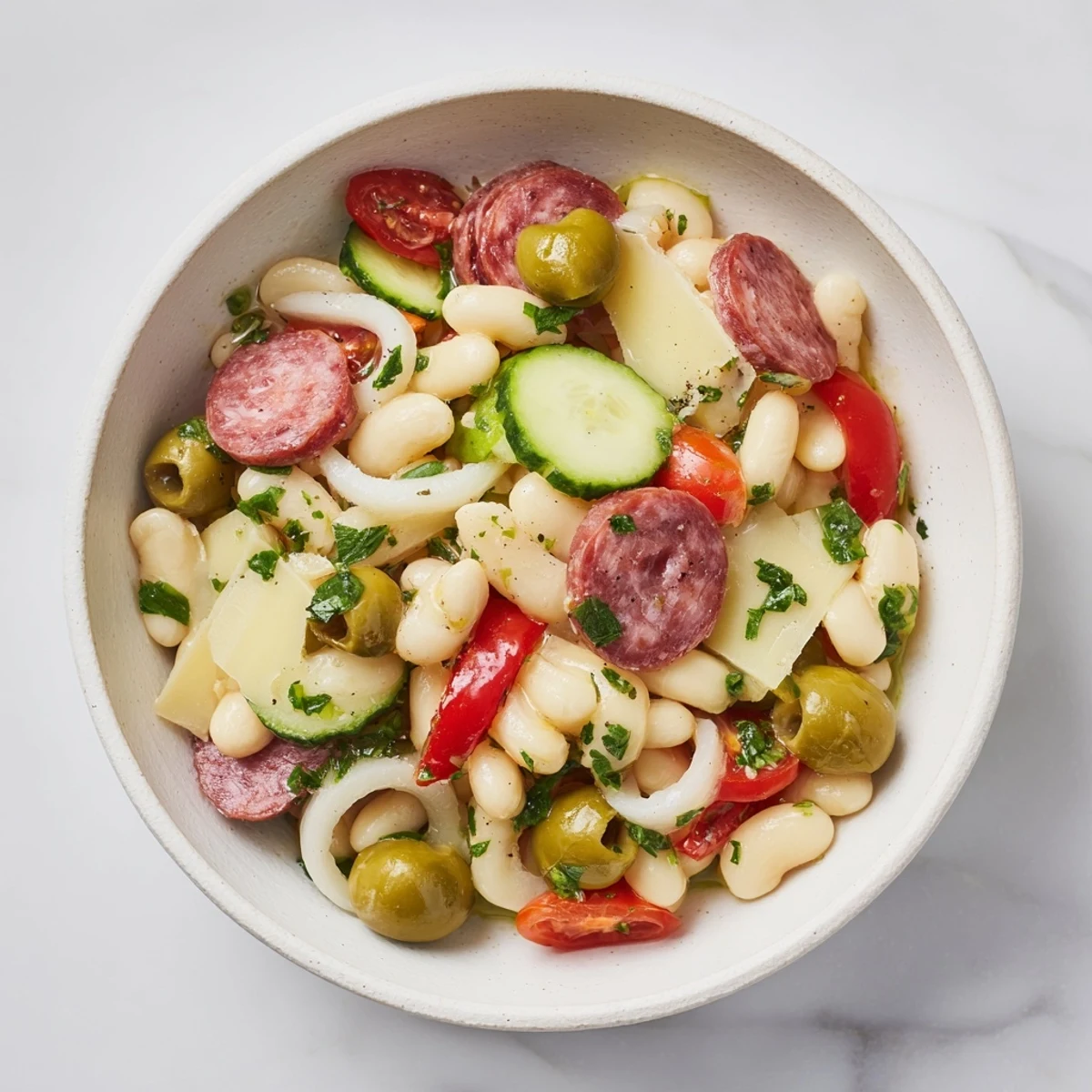 Italian Antipasto Bean Salad: A colorful mix of beans, salami, provolone, and veggies drizzled with zesty Italian dressing.