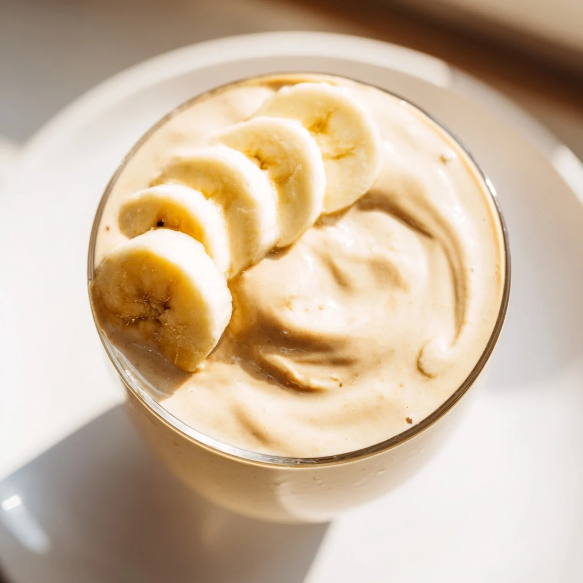 Creamy Peanut Butter Banana Smoothie, swirled in a tall glass, ready for a refreshing breakfast.