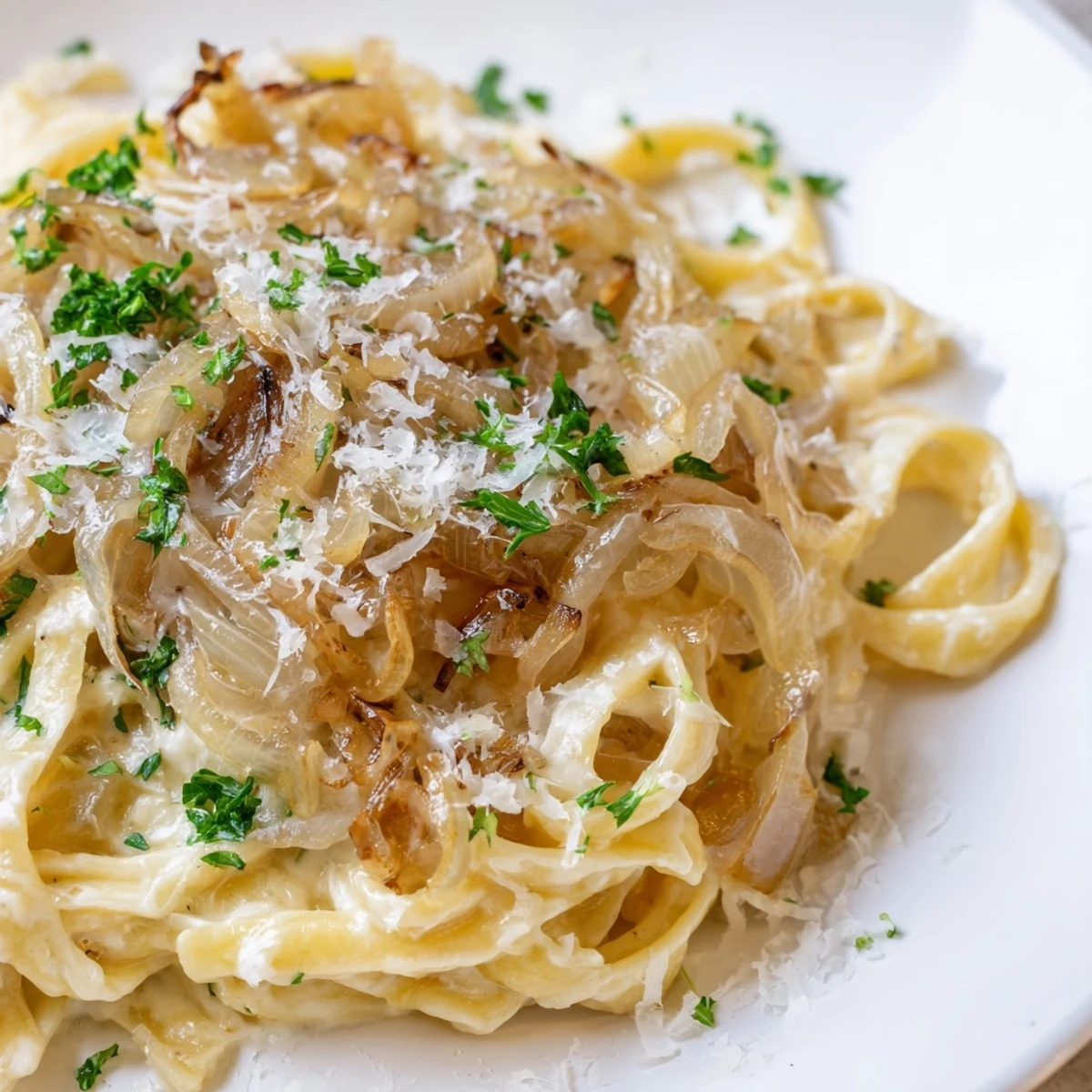 Golden-brown caramelized onions and melted cheese atop the One-Pot French Onion Pasta, a comforting delight.