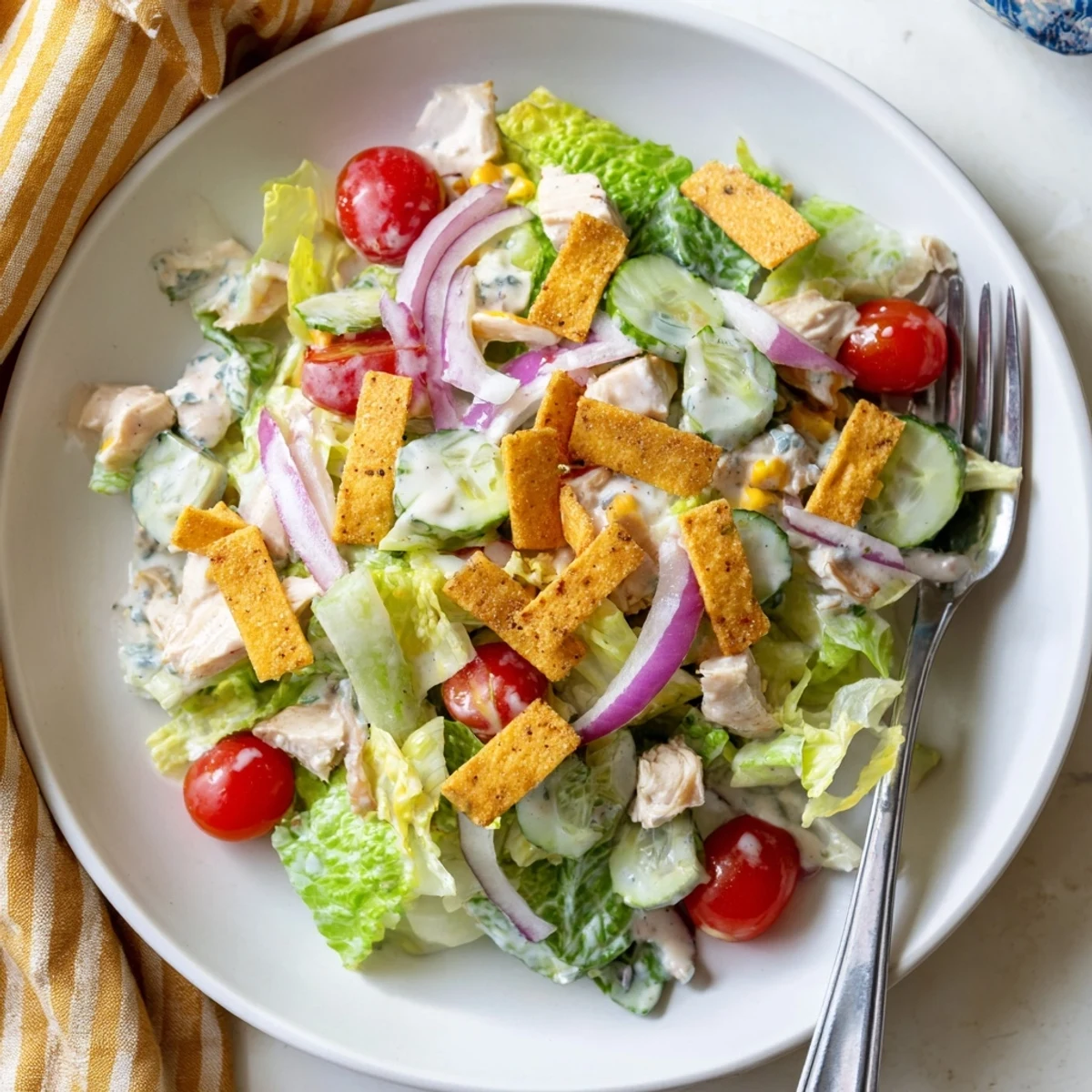 A vibrant bowl of Jalapeño Ranch Chicken Salad featuring juicy grilled chicken, crisp romaine, cherry tomatoes, and creamy avocado slices.