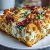 Cheesy vegetarian pasta bake featuring sun-dried tomatoes, ricotta, and spinach baked until golden and bubbly.  