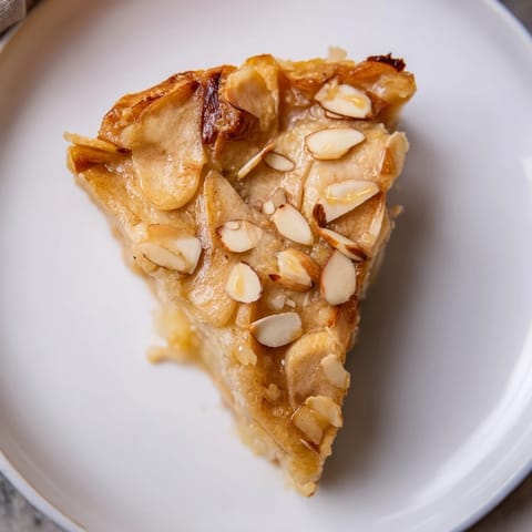 A warm slice of freshly baked Rustic Crustless Apple Pie, wonderfully spiced, perfect for sharing.