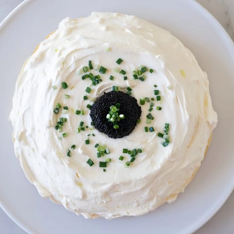 A close-up view of The Diamond Inlay: rich caviar gleaming within a ring of soft cream.