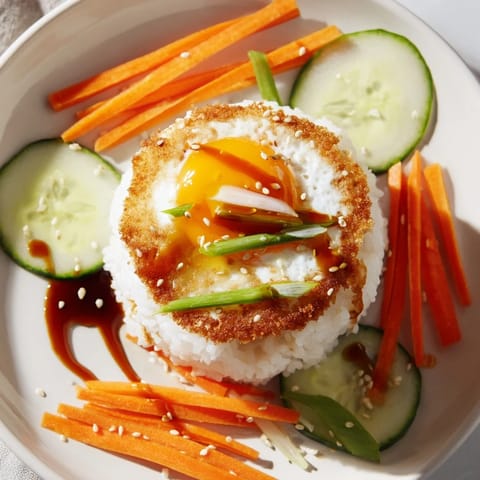 This easy crispy egg rice bowl features a golden fried base topped with fresh, colorful ingredients.