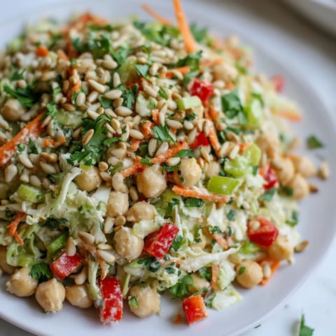 A colorful bowl of Fiber-Forward Chickpea Salad with fresh herbs, ready for a healthy lunch bite.