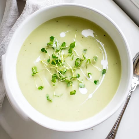 Creamy Celery Root Bisque simmering in a pot, showcasing the velvety texture and pale green hue of the French soup.