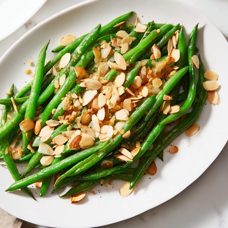Garlic-infused Sautéed Green Beans with Almonds: a close-up shows the vivid green color and crunchy almonds.