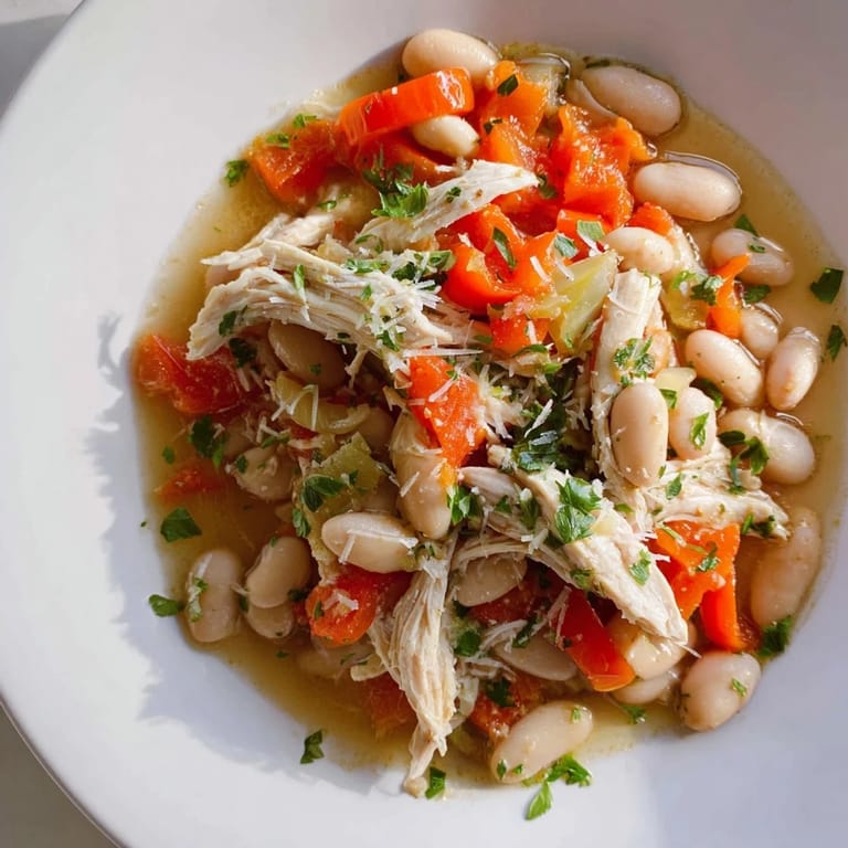 Close-up of a rustic White Bean and Roasted Red Pepper Chicken stew, perfect for chilly evenings.