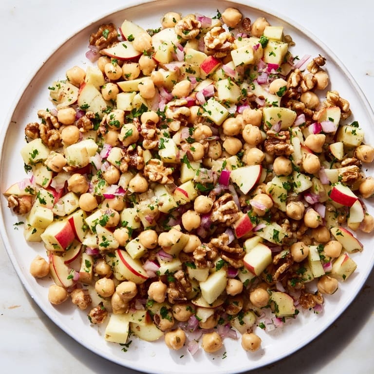 A beautiful bowl of Fall Harvest Apple and Chickpea Salad, perfect for a fresh and flavorful vegetarian lunch option.