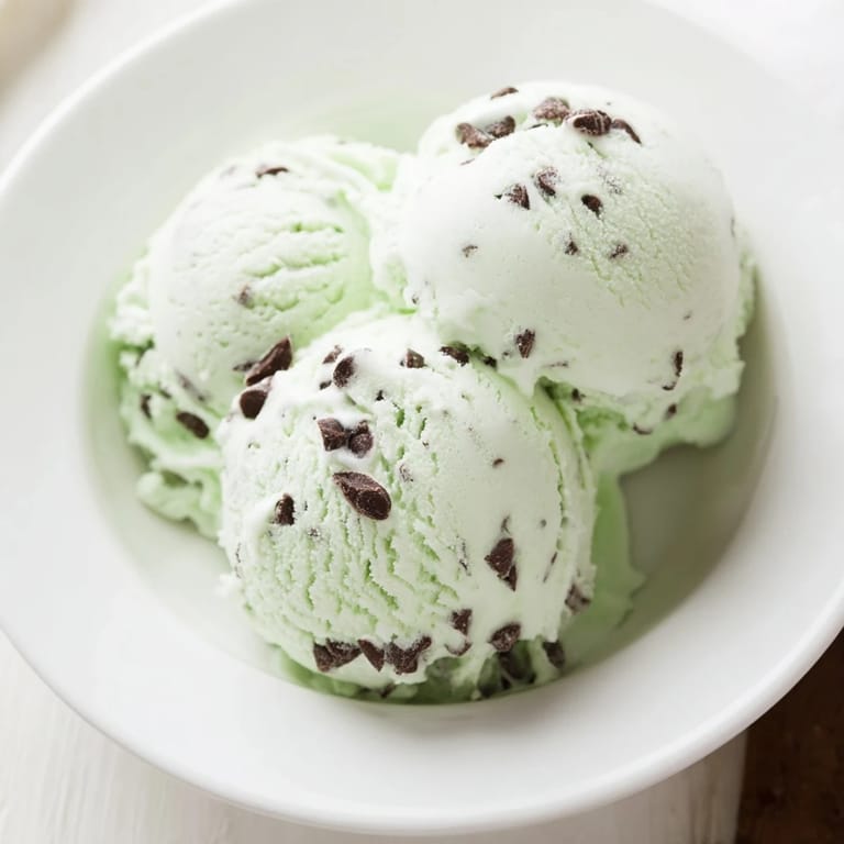A close-up of decadent Mint Chocolate Chip Ice Cream, showing the texture and delicious chocolate flecks.