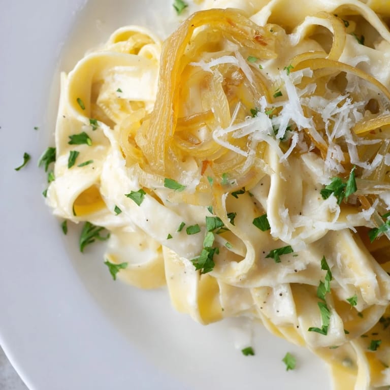 A bubbling skillet shows the finished One-Pot French Onion Pasta, ready for a warm and satisfying dinner.